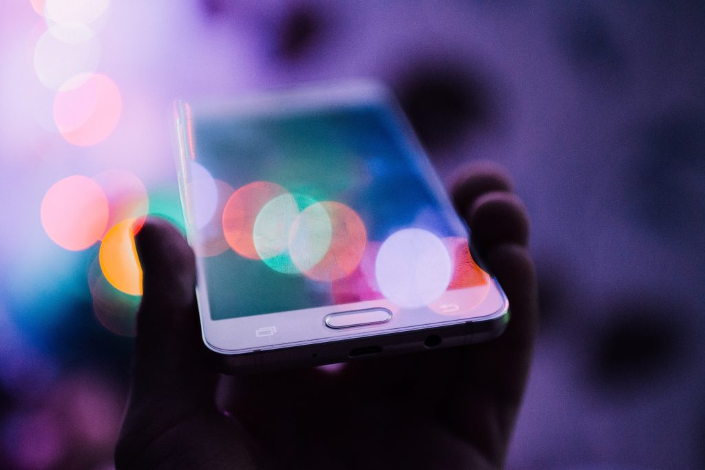 A hand holding a mobile phone.